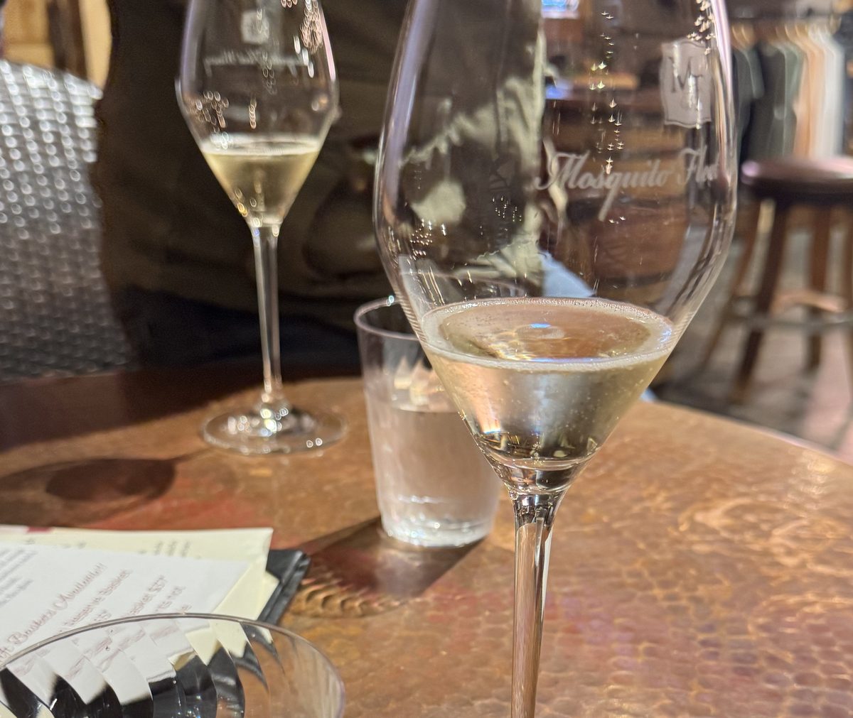 Wine tasting at Mosquito Fleet Winery in Belfair — warm interior with wine glasses on a copper table, Hood Canal area